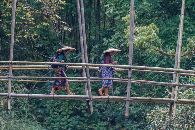 Baduy women crossing a bamboo bridge in West Java, Indonesia