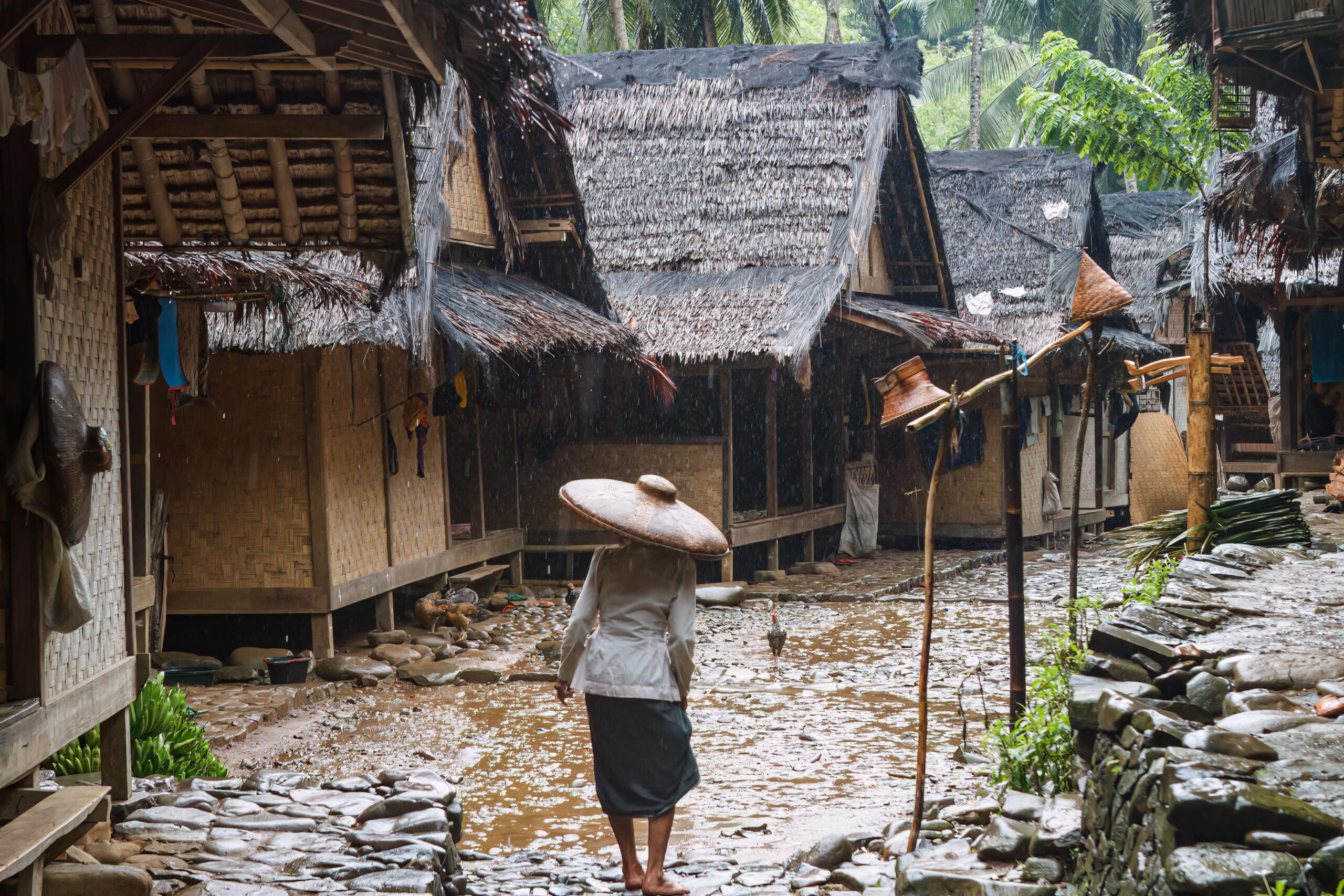 A woman walking through a traditional Baduy, or Kanekes village in West Java, Indonesia
